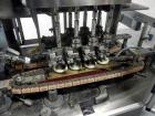 Used Resina Model U40 Automatic Inline Capper. Machine is capable of speeds up to 300 caps per minute. Is a 4 station capper with 8 spindle quills. Adjustable from 10mm-70mm caps. Has top mounted cap...