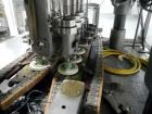 Used Resina Model U40 Automatic Inline Capper. Machine is capable of speeds up to 300 caps per minute. Is a 4 station capper with 8 spindle quills. Adjustable from 10mm-70mm caps. Has top mounted cap...