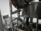 Used Resina Model U40 Automatic Inline Capper. Machine is capable of speeds up to 300 caps per minute. Is a 4 station capper with 8 spindle quills. Adjustable from 10mm-70mm caps. Has top mounted cap...