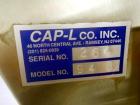 Used Resina Model U40 Automatic Inline Capper. Machine is capable of speeds up to 300 caps per minute. Is a 4 station capper with 8 spindle quills. Adjustable from 10mm-70mm caps. Has top mounted cap...