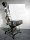 Used Resina Model U40 Automatic Inline Capper. Machine is capable of speeds up to 300 caps per minute. Is a 4 station capper with 8 spindle quills. Adjustable from 10mm-70mm caps. Has top mounted cap...