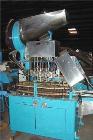 Usedina model U-40 automatic screw capper, 4 quill straight conveyorized dual gripper. Approximate cap range: 13 to 38mm or 43 to 70mm. Approximate speed range: 60-150 per minute. Container range: 1/...
