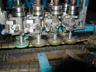 Usedina model U-40 automatic screw capper, 4 quill straight conveyorized dual gripper. Approximate cap range: 13 to 38mm or 43 to 70mm. Approximate speed range: 60-150 per minute. Container range: 1/...