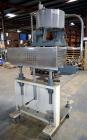Used Sure Kap SK6000-18 Quill capper. Three spindle capper with adjustable chute will handle caps from 13 to 110MM w/o changeparts. Has dual gripper belts, C frame construction will mount up to any c...