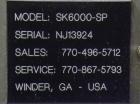 Used SureKap Fully Automatic Straight Line Six Spindle Quill Capper, Model SK6000-SP. Capacities 100 bottles per minute depending on size and conveyor speed. Cap Size Range: diameter 8mm to 110mm (Ma...