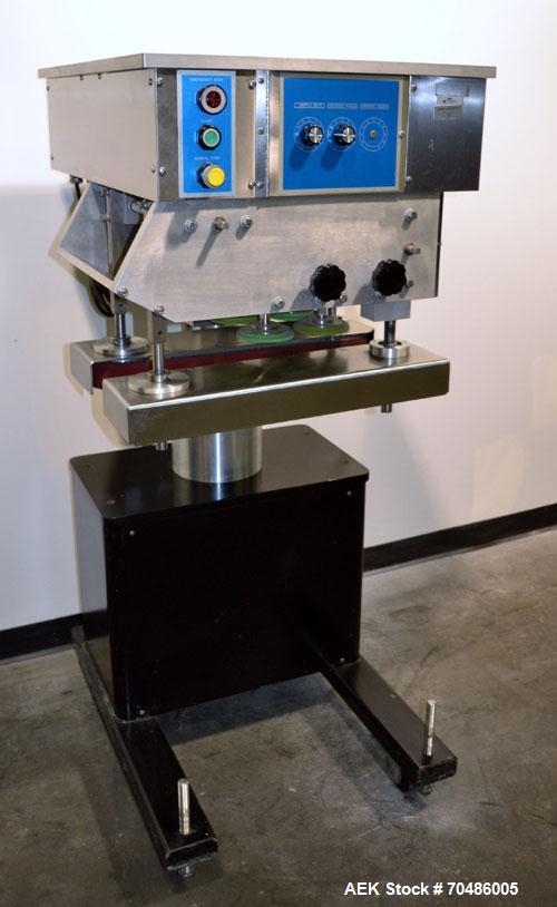 Used Filamatic (National Instruments) Model DL-4-CT 4 Quill Automatic Cap Tightening Machine. Capable of 80 containers per minute. (2) 2’’ Widex 19’’ long gripper belts, driven by a 1/2 hp, 90 volt D...