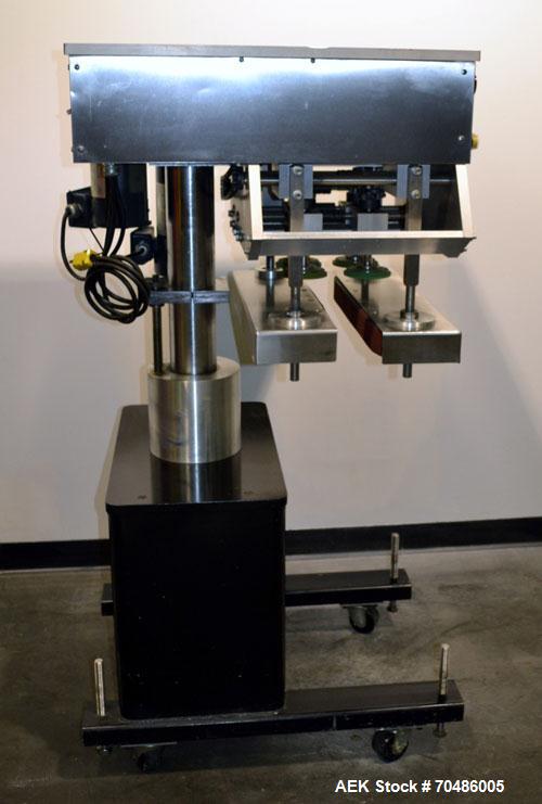 Used Filamatic (National Instruments) Model DL-4-CT 4 Quill Automatic Cap Tightening Machine. Capable of 80 containers per minute. (2) 2’’ Widex 19’’ long gripper belts, driven by a 1/2 hp, 90 volt D...