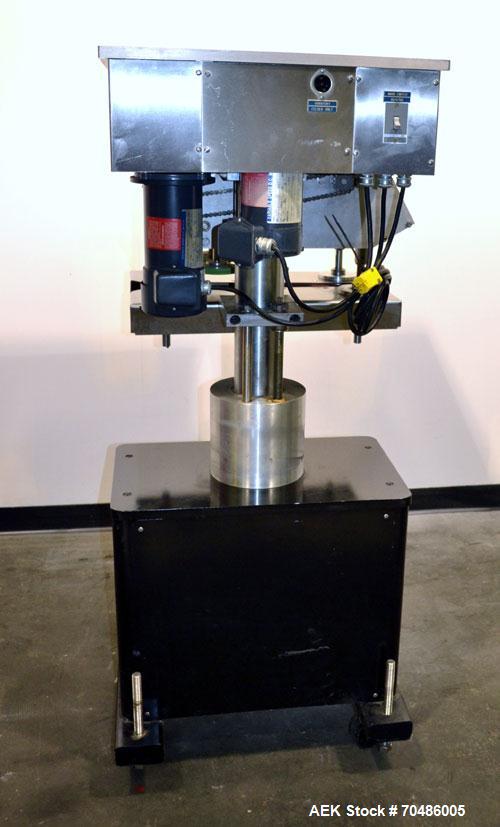 Used Filamatic (National Instruments) Model DL-4-CT 4 Quill Automatic Cap Tightening Machine. Capable of 80 containers per minute. (2) 2’’ Widex 19’’ long gripper belts, driven by a 1/2 hp, 90 volt D...