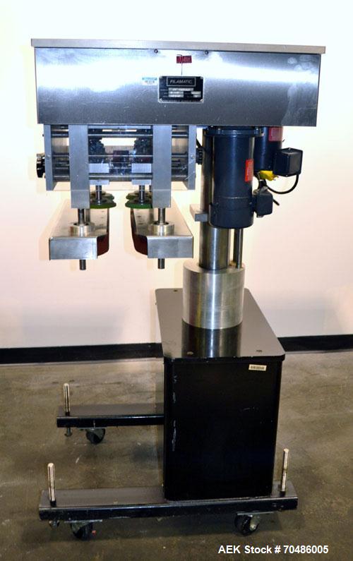 Used Filamatic (National Instruments) Model DL-4-CT 4 Quill Automatic Cap Tightening Machine. Capable of 80 containers per minute. (2) 2’’ Widex 19’’ long gripper belts, driven by a 1/2 hp, 90 volt D...