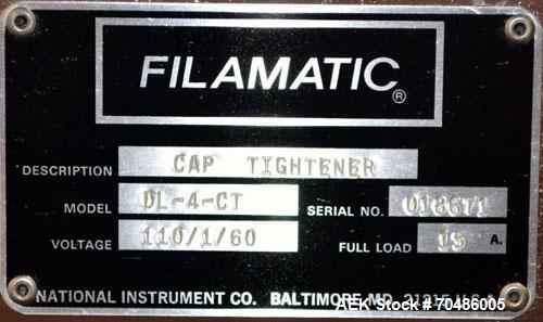 Used Filamatic (National Instruments) Model DL-4-CT 4 Quill Automatic Cap Tightening Machine. Capable of 80 containers per minute. (2) 2’’ Widex 19’’ long gripper belts, driven by a 1/2 hp, 90 volt D...