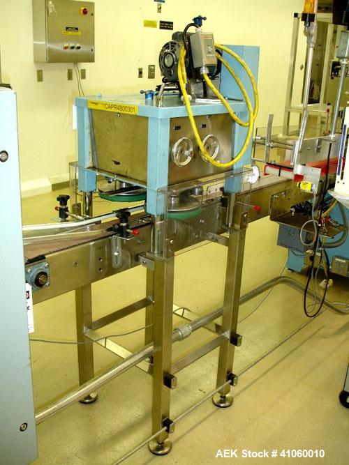 Used Newman Machinery Cap Tightener/Retorquer, Model 4CT. Capable of speeds up to 100 BPM. Cap size range from 13 to 100MM and a container range 13mm to 110mm diameter x 50 to 300mm high. Single side...