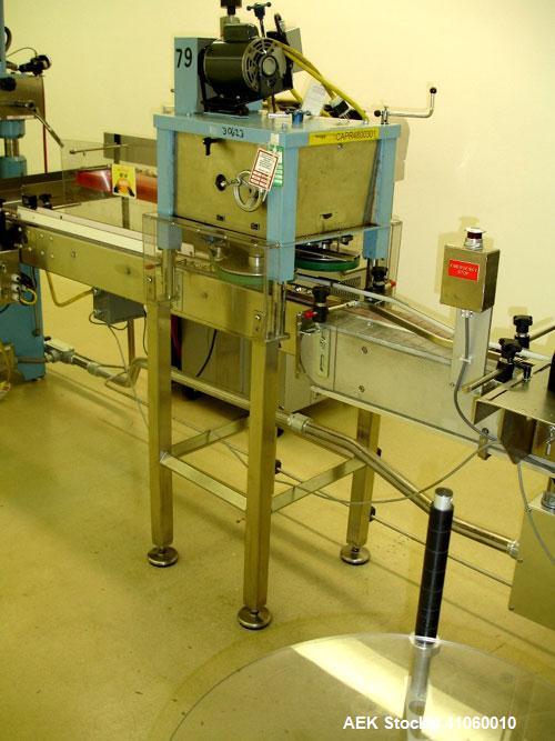 Used Newman Machinery Cap Tightener/Retorquer, Model 4CT. Capable of speeds up to 100 BPM. Cap size range from 13 to 100MM and a container range 13mm to 110mm diameter x 50 to 300mm high. Single side...