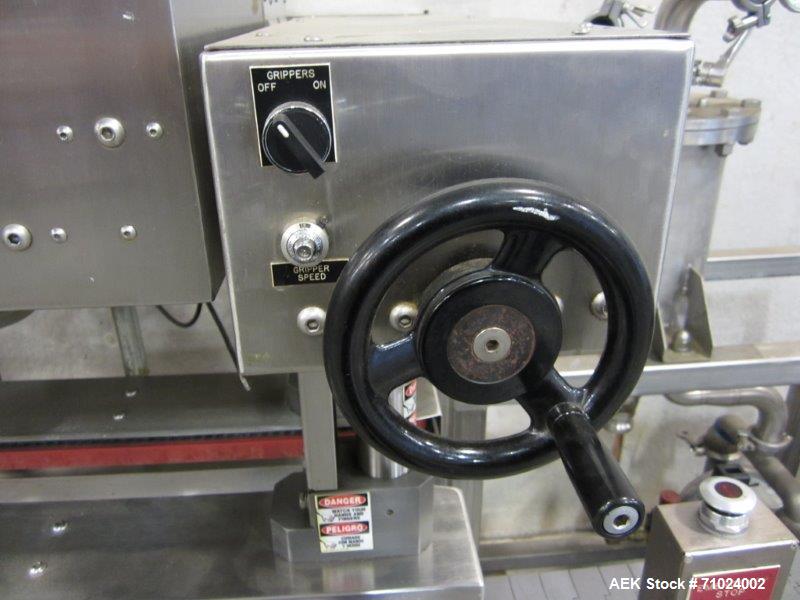 Used Kiss Packaging Model CT-04 Automatic Cap Tightener/Retorquer. Capable of speeds over 100 containers per minute. Has an adjustable cap size range from 13mm - 110mm. Has single belt grippers, hand...