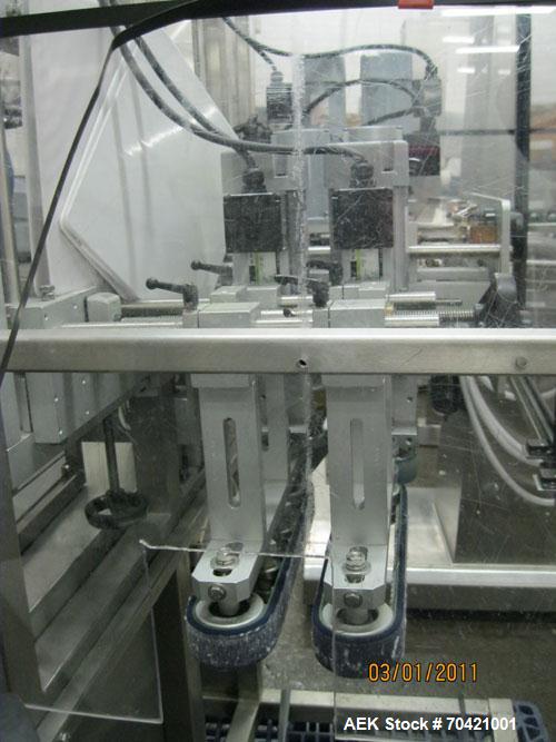 Used New England Machinery Cap Tightener and Retorquer, Model NEPMTE-1F-DB-2. Has dual cap tightening spindles. Single belt grippers. Cap size range:  12 mm to 100 mm or .5" to 4".  Container speeds ...