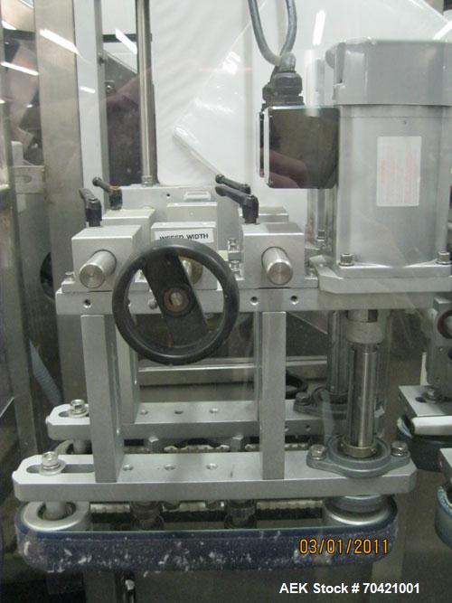 Used New England Machinery Cap Tightener and Retorquer, Model NEPMTE-1F-DB-2. Has dual cap tightening spindles. Single belt grippers. Cap size range:  12 mm to 100 mm or .5" to 4".  Container speeds ...