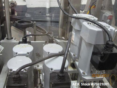 Used New England Machinery Cap Tightener and Retorquer, Model NEPMTE-1F-DB-2. Has dual cap tightening spindles. Single belt grippers. Cap size range:  12 mm to 100 mm or .5" to 4".  Container speeds ...