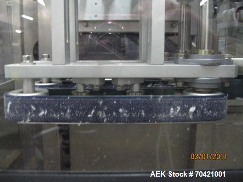 Used New England Machinery Cap Tightener and Retorquer, Model NEPMTE-1F-DB-2. Has dual cap tightening spindles. Single belt grippers. Cap size range:  12 mm to 100 mm or .5" to 4".  Container speeds ...