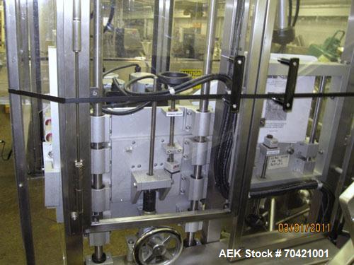 Used New England Machinery Cap Tightener and Retorquer, Model NEPMTE-1F-DB-2. Has dual cap tightening spindles. Single belt grippers. Cap size range:  12 mm to 100 mm or .5" to 4".  Container speeds ...
