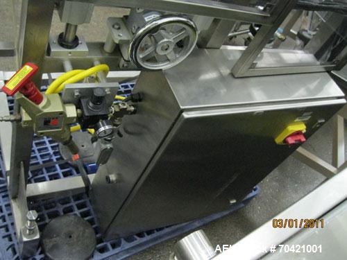 Used New England Machinery Cap Tightener and Retorquer, Model NEPMTE-1F-DB-2. Has dual cap tightening spindles. Single belt grippers. Cap size range:  12 mm to 100 mm or .5" to 4".  Container speeds ...