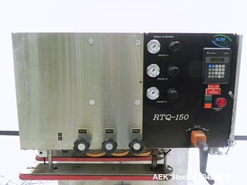 Used New Jersey Machine Model RTQ-150 Cap Tightener and Retorquer. Capable of speeds up to 300 bottles per minute. Stainless steel frame, mounts over existing conveyor. Has single side gripper belts....