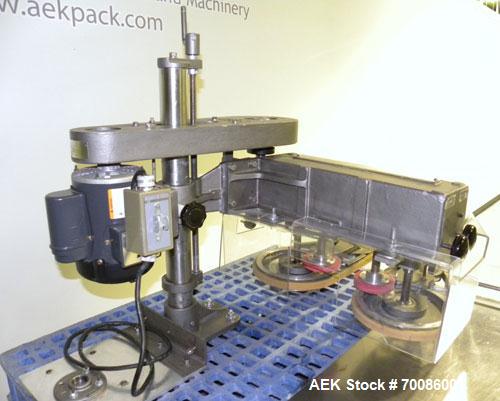 Used Kinsley Universal Roll-Tite Semi- Automatic Two Spindle Cap Tightener/ Retorquer, Model DM4350. Capable of speeds up to 200 containers per minute. Cap size range maximum 5-3/8’’ diameter without...