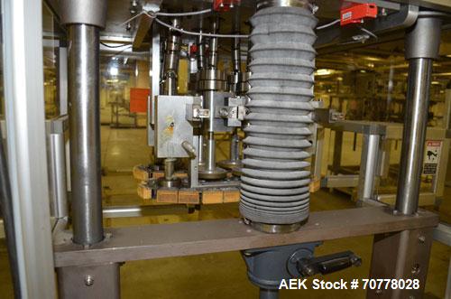 Used Resina Model RT-20 cap tightener retorquer. Capable of speeds up to 90 bottles per minute. Cap size range: 13mm t0 38mm. C frame desing, has two sets of cap tightening wheel, single side belt gr...