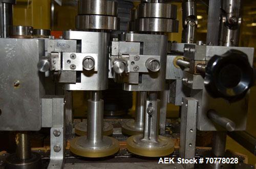 Used Resina Model RT-20 cap tightener retorquer. Capable of speeds up to 90 bottles per minute. Cap size range: 13mm t0 38mm. C frame desing, has two sets of cap tightening wheel, single side belt gr...