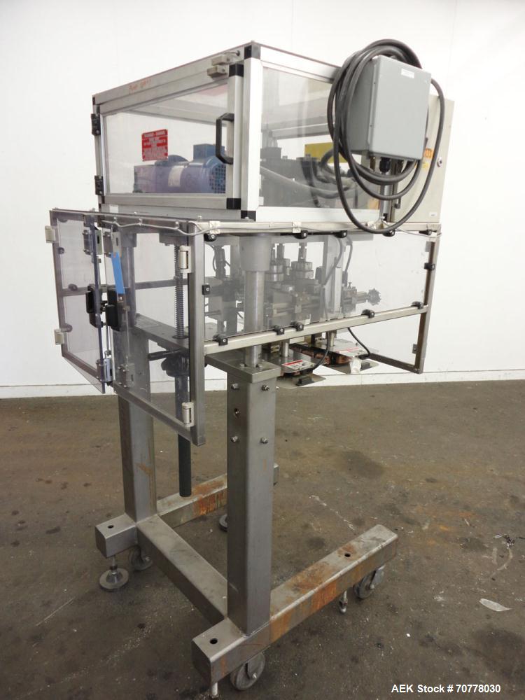Used Resina Model RT-20 Cap Tightener Retorquer capable of speeds up to 90 bottles per minute. Cap size range: 13mm to 38mm. C frame design, has two sets of cap tightening wheels, single side belt gr...