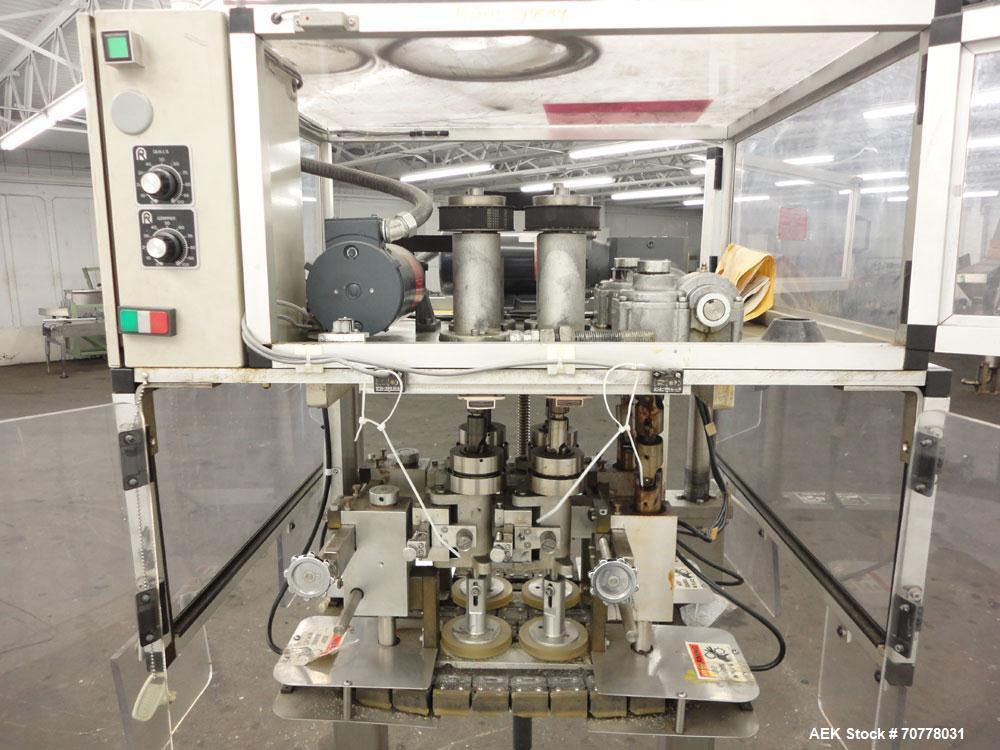 Used Resina Model RT-20 cap tightener retorquer. Capable of speeds up to 90 bottles per minute. Cap size range: 13mm to 38mm. C frame desing, has two sets of cap tightening wheel, single side belt gr...