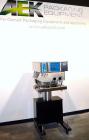 Used Filamatic (National Instruments) Model DL-4-CT 4 Quill Automatic Cap Tightening Machine. Capable of 80 containers per minute. (2) 2’’ Widex 19’’ long gripper belts, driven by a 1/2 hp, 90 volt D...
