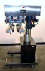 Used Filamatic (National Instruments) Model DL-4-CT 4 Quill Automatic Cap Tightening Machine. Capable of 80 containers per minute. (2) 2’’ Widex 19’’ long gripper belts, driven by a 1/2 hp, 90 volt D...