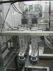 Used New England Machinery Cap Tightener and Retorquer, Model NEPMTE-1F-DB-2. Has dual cap tightening spindles. Single belt grippers. Cap size range:  12 mm to 100 mm or .5