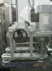 Used New England Machinery Cap Tightener and Retorquer, Model NEPMTE-1F-DB-2. Has dual cap tightening spindles. Single belt grippers. Cap size range:  12 mm to 100 mm or .5