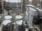 Used New England Machinery Cap Tightener and Retorquer, Model NEPMTE-1F-DB-2. Has dual cap tightening spindles. Single belt grippers. Cap size range:  12 mm to 100 mm or .5