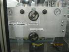 Used New England Machinery Cap Tightener and Retorquer, Model NEPMTE-1F-DB-2. Has dual cap tightening spindles. Single belt grippers. Cap size range:  12 mm to 100 mm or .5