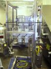 Used New England Machinery Cap Tightener and Retorquer, Model NEPMTE-1F-DB-2. Has dual cap tightening spindles. Single belt grippers. Cap size range:  12 mm to 100 mm or .5