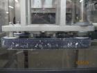 Used New England Machinery Cap Tightener and Retorquer, Model NEPMTE-1F-DB-2. Has dual cap tightening spindles. Single belt grippers. Cap size range:  12 mm to 100 mm or .5