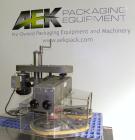 Used Kinsley Universal Roll-Tite Semi- Automatic Two Spindle Cap Tightener/ Retorquer, Model DM4350. Capable of speeds up to 200 containers per minute. Cap size range maximum 5-3/8’’ diameter without...