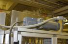 Used Resina Model RT-20 cap tightener retorquer. Capable of speeds up to 90 bottles per minute. Cap size range: 13mm t0 38mm. C frame desing, has two sets of cap tightening wheel, single side belt gr...