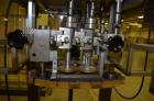 Used Resina Model RT-20 cap tightener retorquer. Capable of speeds up to 90 bottles per minute. Cap size range: 13mm t0 38mm. C frame desing, has two sets of cap tightening wheel, single side belt gr...