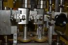 Used Resina Model RT-20 cap tightener retorquer. Capable of speeds up to 90 bottles per minute. Cap size range: 13mm t0 38mm. C frame desing, has two sets of cap tightening wheel, single side belt gr...