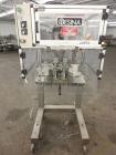 Used Resina Model RT-20 cap tightener retorquer. Capable of speeds up to 90 bottles per minute. Cap size range: 13mm to 38mm. C frame desing, has two sets of cap tightening wheel, single side belt gr...