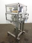Used Resina Model RT-20 cap tightener retorquer. Capable of speeds up to 90 bottles per minute. Cap size range: 13mm to 38mm. C frame desing, has two sets of cap tightening wheel, single side belt gr...