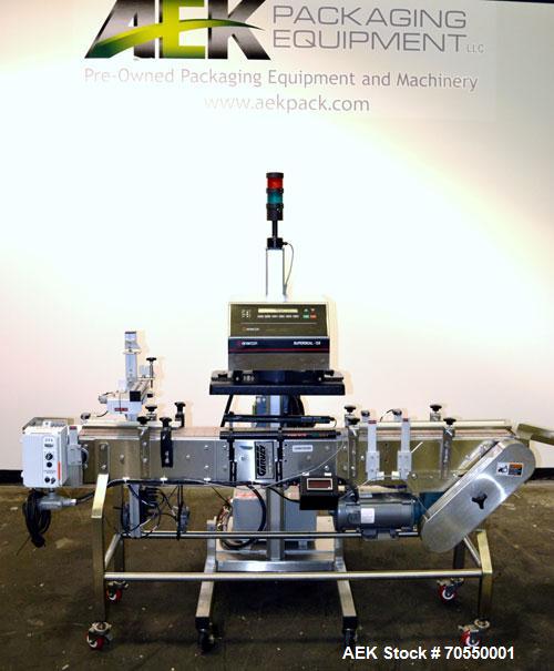 Used Enercon Superseal DX Air Cooled Induction Sealer. Model LM4466-1. 3/50/60 HZ, 240 volt, 8.7 amps. Mounted on an adjustable height stand. Includes seal detection, stalled bottle sensor, input tra...