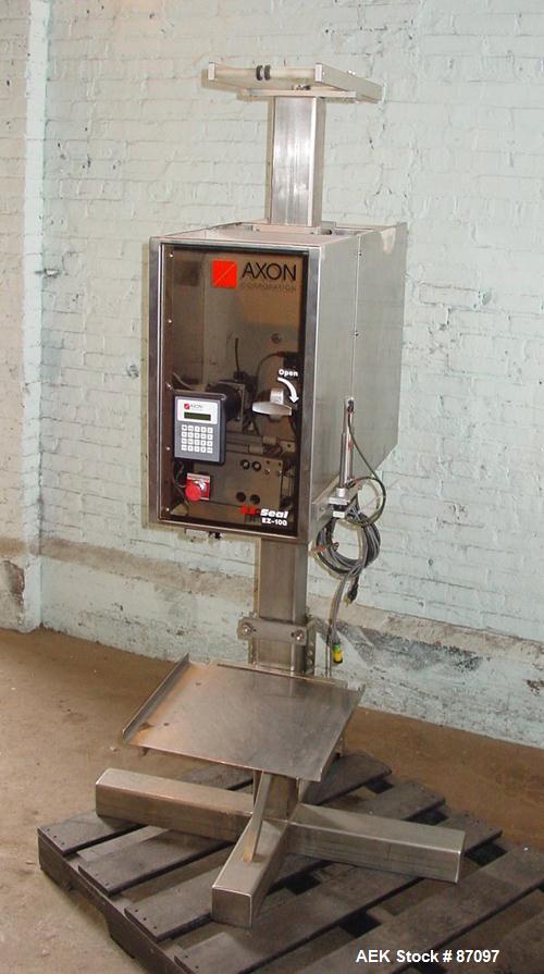 Used Axon Heat Shrink Tamper Evident Band & Sleeve Label Applicator, Model EZ100, Stainless Steel. Rated up to 150 ppm depending on the container. Sleeve size 20 to 100mm flat x 25 to 200mm high x 40...