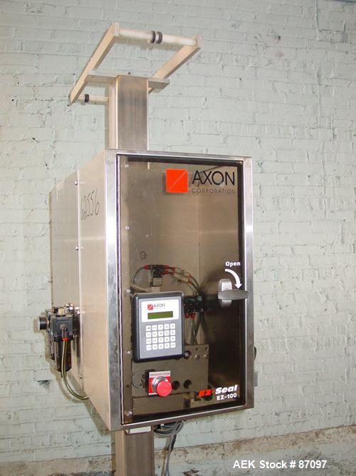 Used Axon Heat Shrink Tamper Evident Band & Sleeve Label Applicator, Model EZ100, Stainless Steel. Rated up to 150 ppm depending on the container. Sleeve size 20 to 100mm flat x 25 to 200mm high x 40...