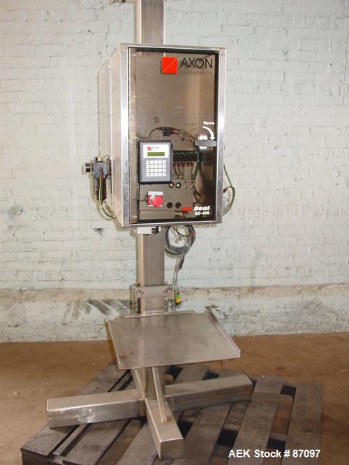 Used Axon Heat Shrink Tamper Evident Band & Sleeve Label Applicator, Model EZ100, Stainless Steel. Rated up to 150 ppm depending on the container. Sleeve size 20 to 100mm flat x 25 to 200mm high x 40...