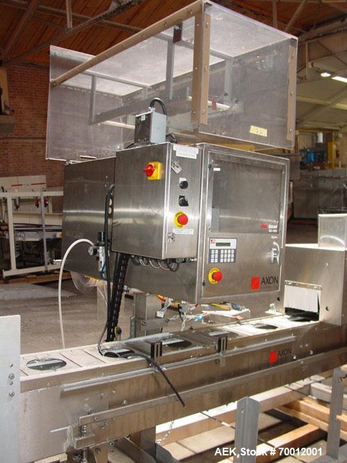Used Axon EZ300 Stainless Steel Neck Bander With Stainless Steel Tunnel. Capable of speeds up to 70 containers per minute. Can handle product container widths from 2-3/8" to 7-3/8" and sleeve lay fla...