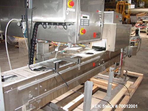 Used Axon EZ300 Stainless Steel Neck Bander With Stainless Steel Tunnel. Capable of speeds up to 70 containers per minute. Can handle product container widths from 2-3/8" to 7-3/8" and sleeve lay fla...