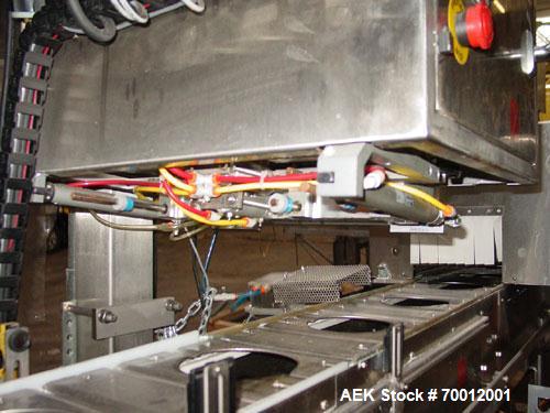 Used Axon EZ300 Stainless Steel Neck Bander With Stainless Steel Tunnel. Capable of speeds up to 70 containers per minute. Can handle product container widths from 2-3/8" to 7-3/8" and sleeve lay fla...